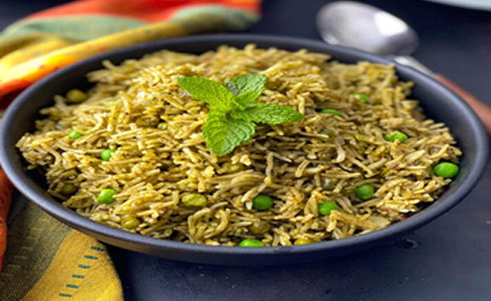 A Bowl  of green rice which is included mint and green Pease